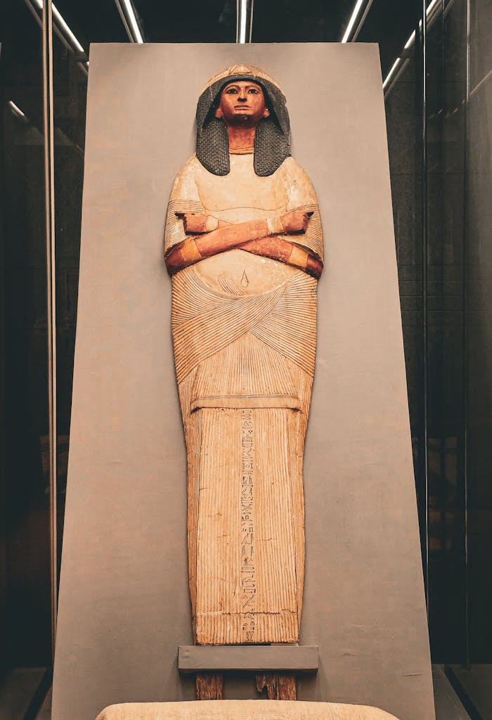 Photograph of an ancient Egyptian sarcophagus exhibited in a museum setting.